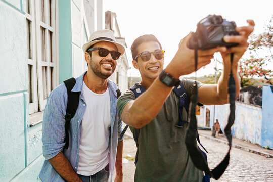 Two happy male tourists taking self portrait. Travel and love concept in Latin America