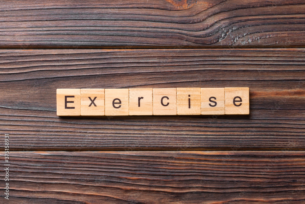 Fototapete exercise word written on wood block. exercise text on table, concept