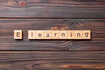E learning word written on wood block. Elearning text on cement table for your desing, concept