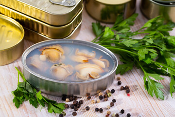 Open tin can with sea clams in its own juice. High quality photo
