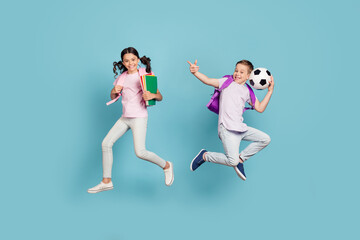Fototapeta na wymiar Full length body size view of his he her she attractive small little cheerful friends friendship jumping having fun playing football cup goal free time isolated blue pastel color background