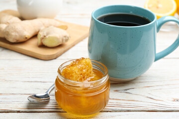 Tasty honey with combs and drink on white wooden table