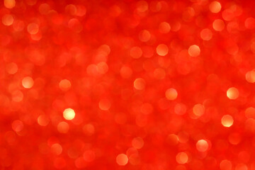 Defocused Golden lights.Abstract red bokeh texture background.Christmas shiny background. The concept of the celebration or party