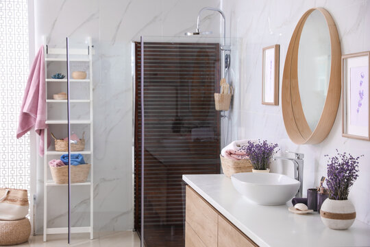 Bathroom interior with shower stall, counter and shelving unit. Idea for design