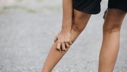 Young female athlete suffering from calf pain ,Injury from workout concept © anut21ng Stock