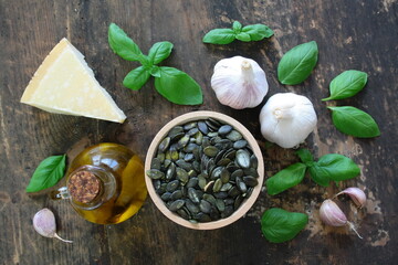 Pesto products: olive oil, pumpkin seeds, basil, Parmesan, and garlic