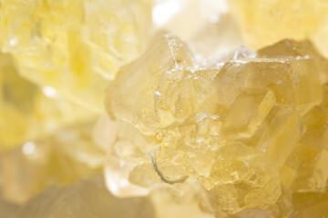Brown yellow sugar crystals, macro closeup. Sweet background