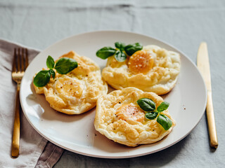 Fluffy Cloud Eggs. Trendy food - oven bake scrambled eggs with whipped egg white and whole yolk on plate