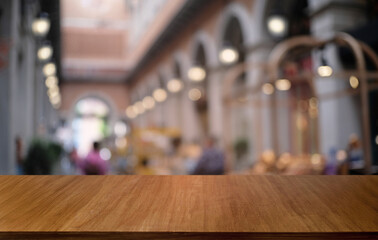 Empty dark wooden table in front of abstract blurred bokeh background of restaurant . can be used for display or montage your products.Mock up for space.