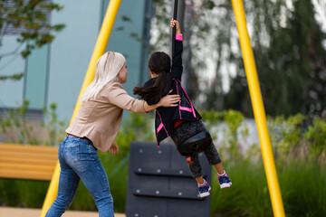 Obraz premium The little girl on the bungee jumping for kids outdoor.