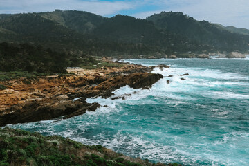Rocky coast in Big Sur, waves crashing on rocks