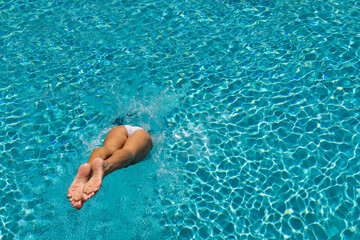 woman diving  at luxury five stars  spa resort in the swimming pool