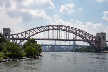 The Hell Gate Bridge along the Astoria Queens New York Riverfront over the East River during Summer