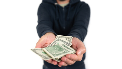 midsection of caucasian man offering or handing over dollar bills to someone else against white background