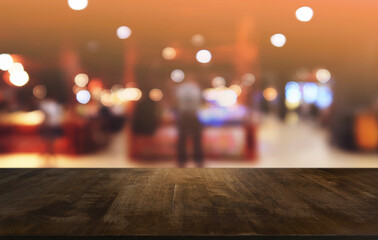 Empty dark wooden table in front of abstract blurred bokeh background of restaurant . can be used for display or montage your products.Mock up for space.