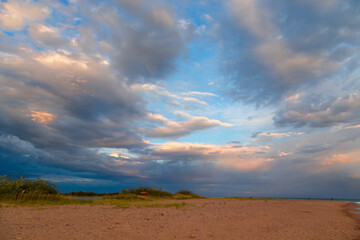 Bright cumulus clouds against the blue sky. Sunset sky Natural background.