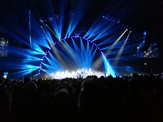 View of the stage at a Killers concert in Birmingham United Kingdom.  Light show and packed arena 
