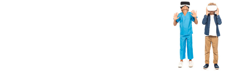 panoramic shot of kids in virtual reality headsets isolated on white