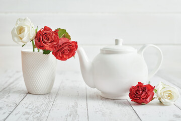 Valentine day romantic breakfast with red roses and teapot. Happy Valentine's day greeting card. Mothers and women's day congratulations. Happy Birthday! Wedding invitation. Love concept.