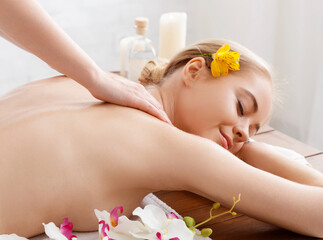 Obraz na płótnie Canvas Thai body massage. Enjoying massage smiling girl