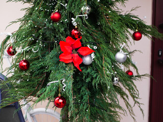 red garland balls hanging on the tree