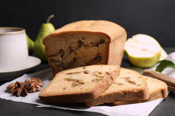 Composition with tasty pear bread on black slate table, closeup. Homemade cake