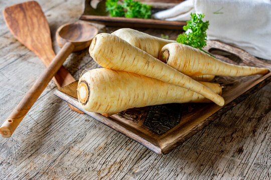 fresh and raw parsnips on wooden table