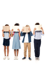 multicultural schoolkids covering faces with books isolated on white