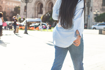 beautiful girl walks around the city in jeans