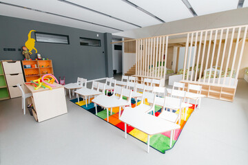 Empty Kindergarten Classroom Interior. Chairs, table and toys