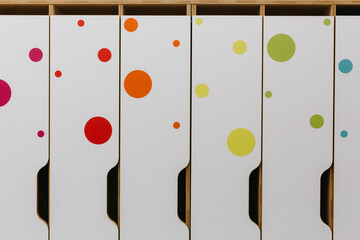 multicolored baby wardrobes in dressing room