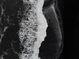 Abstract nature background. Aerial drone view of Reynisfjara Black Sand Beach and ocean waves in South Iceland near Vik village