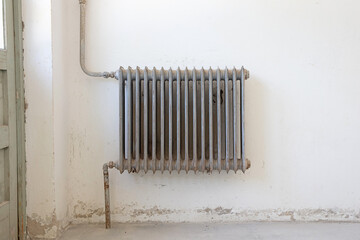Old radiator in an empty historic home