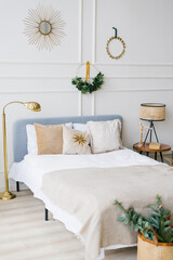 Сozy bedroom with bed and christmas garland lights at home