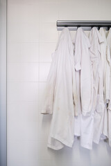 Dirty lab coats hanging in a laboratory. Research concept.