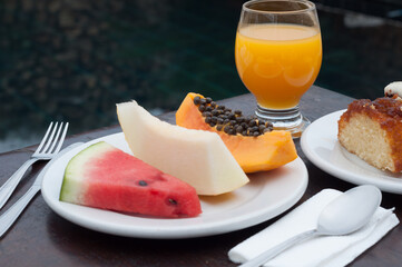 Healthy and fresh breakfast with fruits, like watermelon, papaya, melon, and a delicious orange...