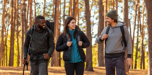 Close up of smiling friends hiking at forest