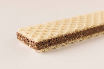 Waffle with chocolate on a light background. Selective focus.