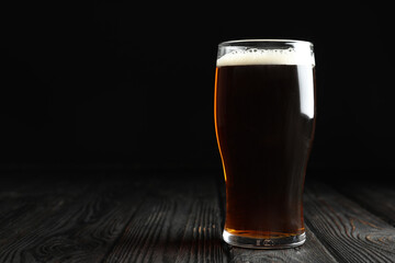 Glass of delicious kvass on wooden table. Space for text