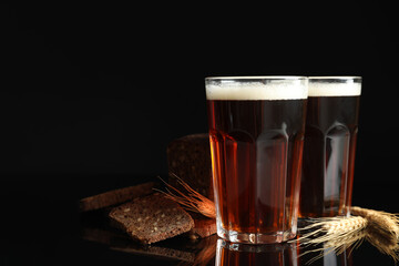 Delicious kvass, bread and spikes on black background