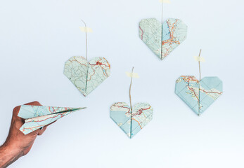 Travel concept: Origami plane with origami heart destinations