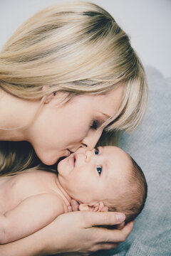 Mother kisses her baby son