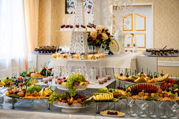 Wedding sweets, decorated tables, decorations and cupcakes, delicious meat and delicacies