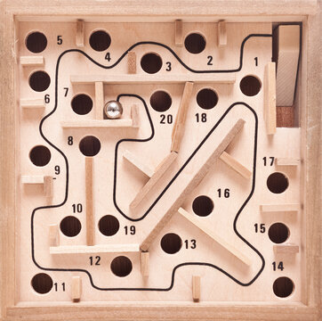 Wooden maze game with silver ball