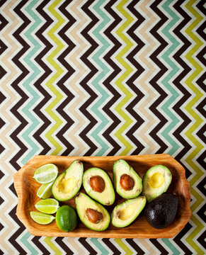 Food: Avocados and Limes on a Wooden Tray