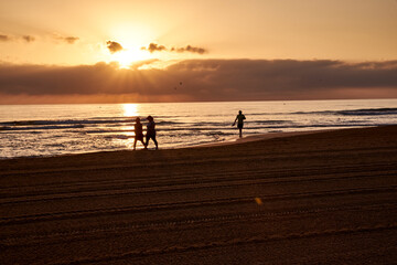 walking along the beach at dawn