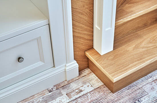 Detail of wooden staircase with built-in wardrobe