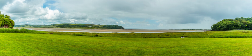 Fototapeta na wymiar A panorama view of the Taff estuary at Laugharne, Wales in the summertime