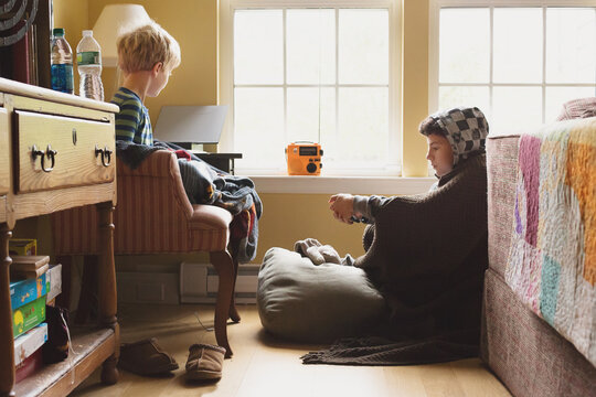 Two Boys Huddled Around a Transistor Radio