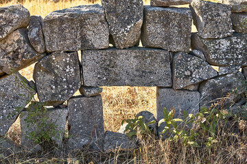 old stone wall with opening